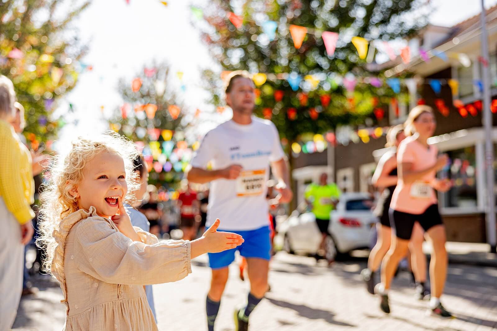 Spectators cheering on runners at a Golazo sporting event